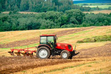 Fototapeta na wymiar Tractor with plow