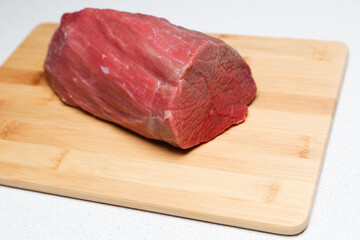 raw meat is on cutting board close up