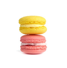 pink and yellow round baked macarons isolated on a white background