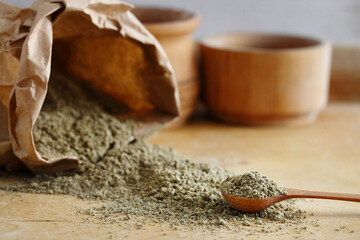 Poppy seeds with poppy flour on wooden table. Coeliac disease concept.