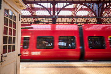 A train at a train-station going fast