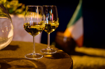 Two glasses of cold dry white wine served outdoor in cafe at night in Italy