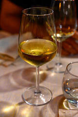 Two glasses of cold dry white wine served outdoor in cafe at night in Italy