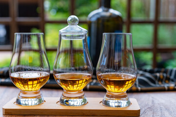 Tasting of Scotch whisky in traditional old British house with wooden windows
