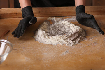 Homemade production of fresh healthy bread of other pastry from natural ingredients on a light grey background.