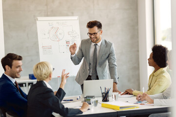 Young businessman communicating with his colleagues during a meeting in the office.