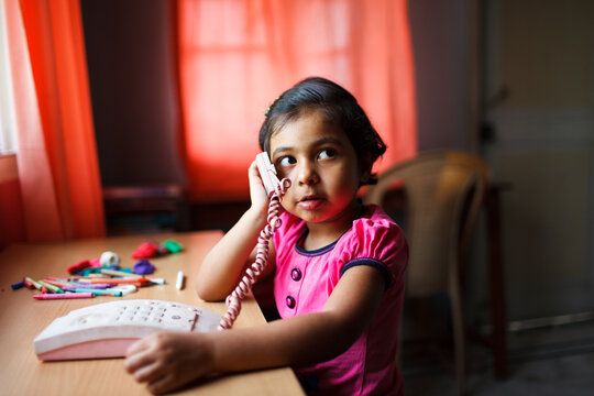 Cute little girl talking on the telephone