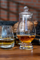 Tasting of Scotch whisky in traditional old house with shadow from British windows