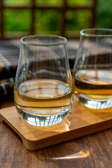 Tasting of Scotch whisky in traditional old British house with wooden windows