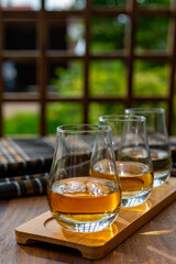 Tasting of Scotch whisky in traditional old British house with wooden windows