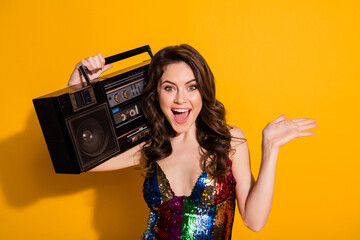 Close-up portrait of her she nice-looking attractive cheerful cheery wavy-haired girl spending weekend carrying boombox isolated bright vivid shine vibrant yellow color background - obrazy, fototapety, plakaty