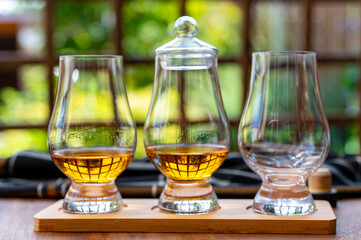 Tasting of Scotch whisky in traditional old British house with wooden windows
