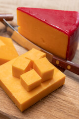 Red waxed yellow cheddar cheese close up