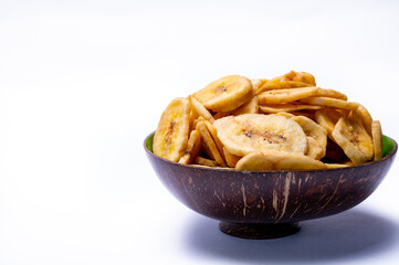 Healthy snack, crispy dehydrated unsugared banana chips in bowl on white background