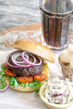 Hamburger and cola in table setting.