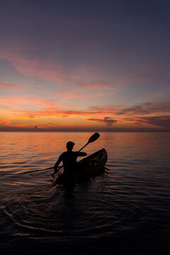Man in Kayak Rowing In The Sea