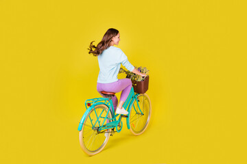 Full body size back photo of pretty charming young girl ride retro bicycle ride through...