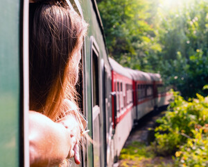 Woman looking out the window of the old train. Bulgarian mountains, Alpine railway in the Balkans