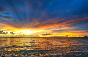 Beautiful summer sunrise over the tropical sea and beach in thailand. Water reflection on a shore.