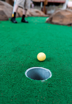 Boy plays mini golf