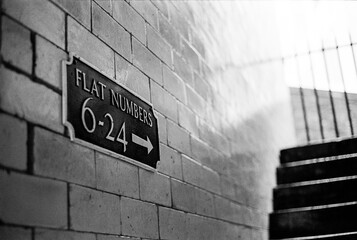 Flat Numbers"" sign near stairs