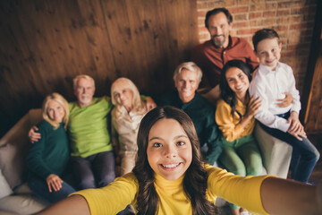 Closeup portrait photo of big full family eight people gathering cuddle embrace small girl daughter make selfie beaming smile sitting sofa generation in home evening living room indoors