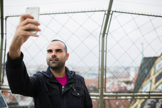 Man taking self-portrait outdoors