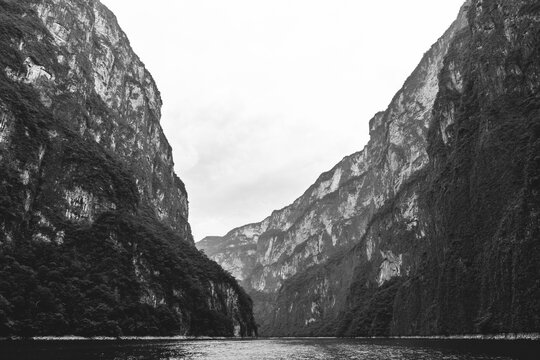 Black and White Scenic valley view of canyon and lake surrounded by vegetation in Chiapas, Mexico.