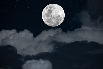 Fototapeta na wymiar Full moon over clouds at night.
