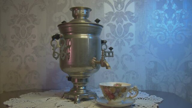 Vintage Samovar Metal Tea Kettle Illuminated by Blue and Pink Light. Video Dolly Arc Right.