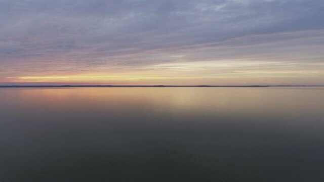 Curonian Lagoon and Thin Sand Dunes Curonian Spit At Sunset. Aerial Slow Pan Right