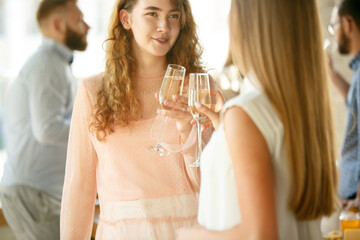 Happiness. People clinking glasses with wine or champagne. Happy cheerful friends celebrate holidays, meeting. Close up shot of smiling friends, lifestyle. Party at home or in restaurant, cafe.