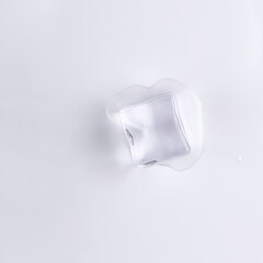 Ice cube isolated on white background. Single ice cube melting. Deep focus stacking.