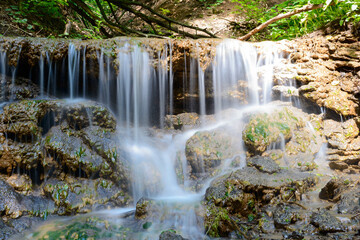 Small forest waterfall on a Sunny summer day