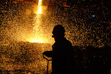 Steelmaker at ingot casting. Electric arc furnace shop EAF. Metallurgy.