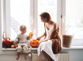 Happy family preparing for Halloween at home together.