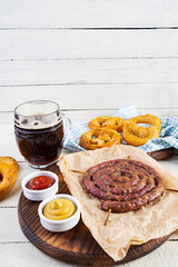 Food menu for Oktoberfest. Sausage with different sauce, pretzel and glass of dark beer