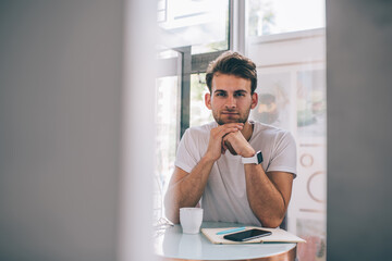 Fototapeta premium Thoughtful man working in cafe