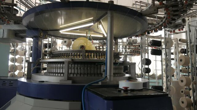 Textile factory. Automated modern fabric production. Machines make fabric from threads.