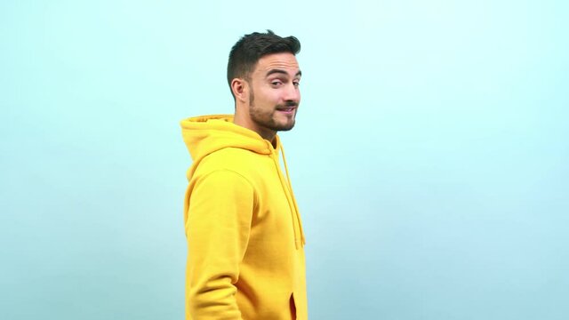 Young caucasian man whispering gossip undertone, trying not to be heard