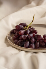 fresh juicy grapes on a plate on a light background