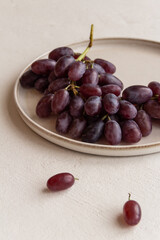 fresh juicy grapes on a plate on a light background