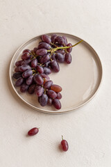 fresh juicy grapes on a plate on a light background