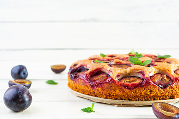 Delicious homemade plum pie on white background