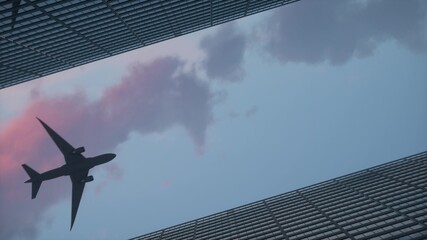 Airplane flying over the top big city skyscraper office buildings. 3d illustration