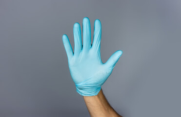Hand in blue medical glove