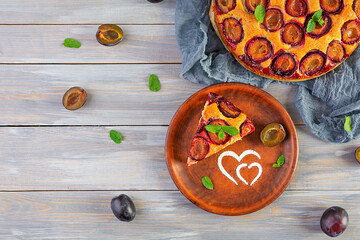 Delicious homemade plum pie on wooden background. Top view