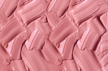 Pale pink cosmetic clay (alginate facial mask, face cream, body wrap) texture close up, selective focus. Abstract background with brush strokes.