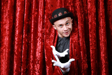 master ceremony on the stage in white gloves at red background