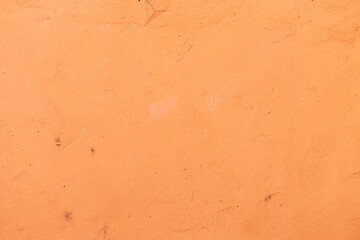 Background and texture of a concrete wall painted with salmon paint